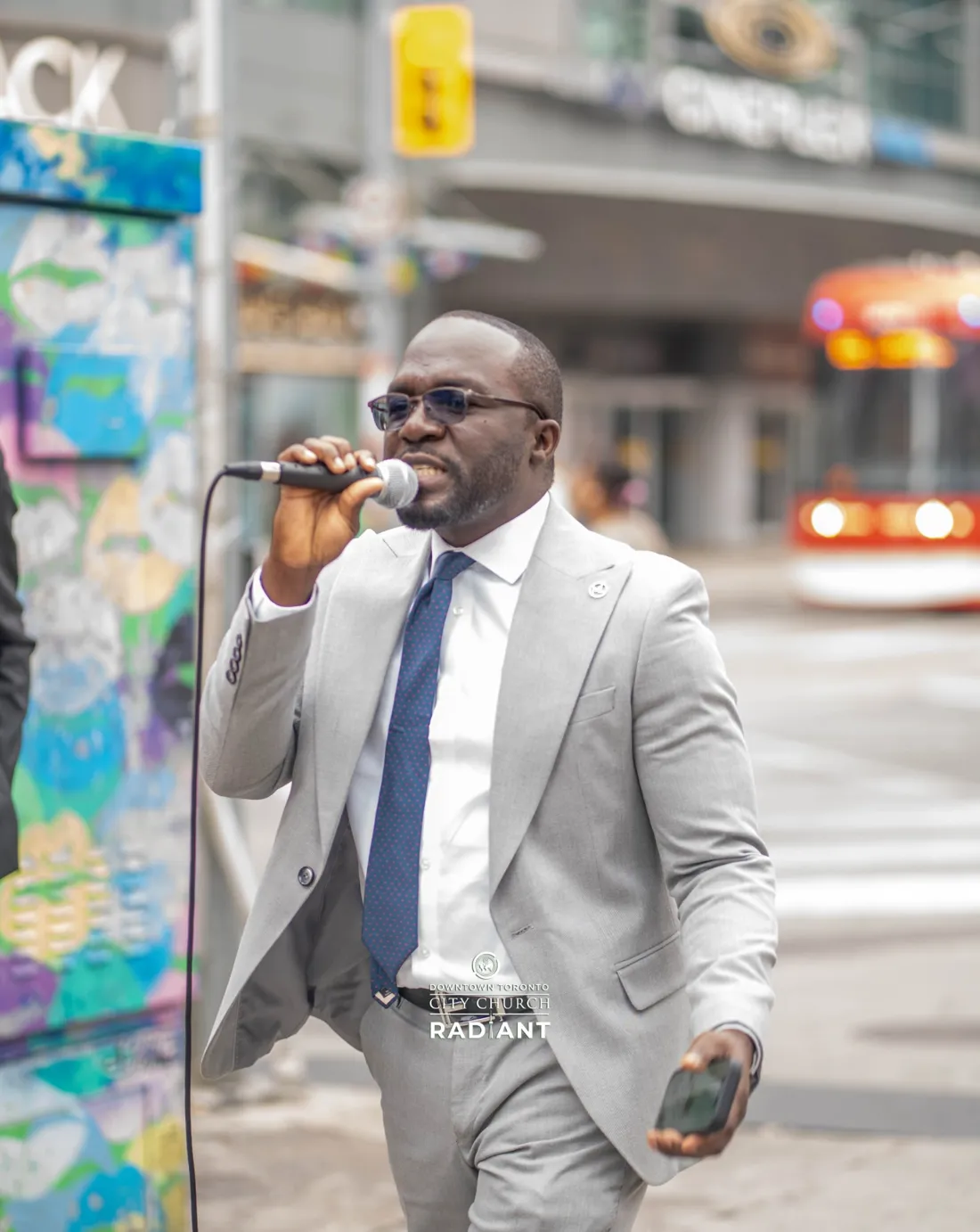 A Radiant City Church minister preaching on a downtown Toronto street corner